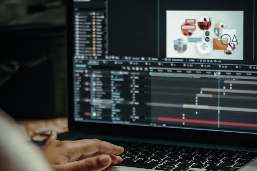 person using macbook pro on table